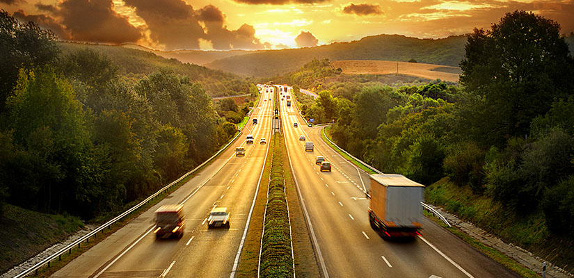 cars on a highway at sunset